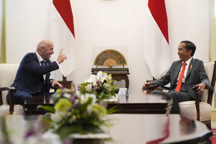 Indonesian President Joko Widodo, right, talks with FIFA President Gianni Infantino during their meeting at Merdeka Palace in Jakarta, Indonesia, Tuesday, Oct. 18, 2022. (AP Photo/Achmad Ibrahim)