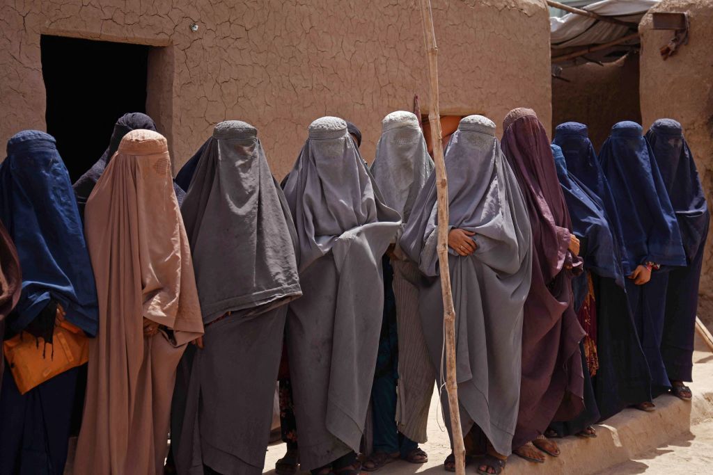 TOPSHOT - Afghan burqa-clad women workers at a shampoo and soap factory in Kandahar on July 30, 2022. (Photo by Javed TANVEER / AFP) (Photo by JAVED TANVEER/AFP via Getty Images)