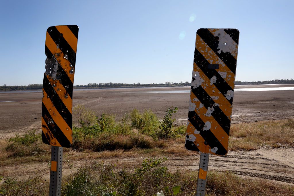 PORTAGEVILLE, MISSOURI - OCTOBER 18: Treasure hunters comb the shoreline of the Mississippi River after it was exposed by low water levels on October 18, 2022 near Portageville, Missouri. Lack of rain in the Ohio River Valley and along the Upper Mississippi has caused the Mississippi River south of the confluence of the Ohio River to reach near record low levels. This condition is wreaking havoc with barge traffic, driving up shipping prices and threatening crop exports and fertilizer shipments as the soybean and corn harvest gets into full swing. (Photo by Scott Olson/Getty Images)