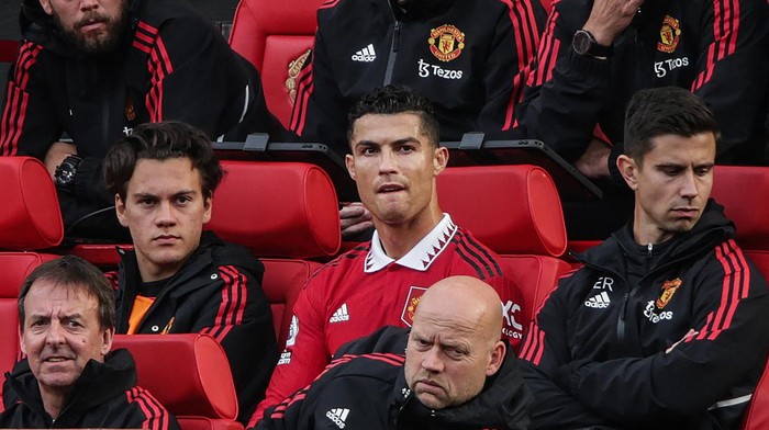 Manchester Uniteds Portuguese striker Cristiano Ronaldo (C) reacts as he sits on the bench during the English Premier League football match between Manchester United and Newcastle at Old Trafford in Manchester, north west England, on October 16, 2022. - RESTRICTED TO EDITORIAL USE. No use with unauthorized audio, video, data, fixture lists, club/league logos or live services. Online in-match use limited to 120 images. An additional 40 images may be used in extra time. No video emulation. Social media in-match use limited to 120 images. An additional 40 images may be used in extra time. No use in betting publications, games or single club/league/player publications. (Photo by Ian Hodgson / AFP) / RESTRICTED TO EDITORIAL USE. No use with unauthorized audio, video, data, fixture lists, club/league logos or live services. Online in-match use limited to 120 images. An additional 40 images may be used in extra time. No video emulation. Social media in-match use limited to 120 images. An additional 40 images may be used in extra time. No use in betting publications, games or single club/league/player publications. / RESTRICTED TO EDITORIAL USE. No use with unauthorized audio, video, data, fixture lists, club/league logos or live services. Online in-match use limited to 120 images. An additional 40 images may be used in extra time. No video emulation. Social media in-match use limited to 120 images. An additional 40 images may be used in extra time. No use in betting publications, games or single club/league/player publications. (Photo by IAN HODGSON/AFP via Getty Images)