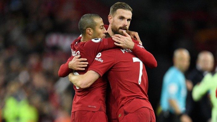 Liverpools Spanish midfielder Thiago Alcantara (L), Liverpools English midfielder Jordan Henderson (C) and  Liverpools English midfielder James Milner (R) celebrate on the pitch after the English Premier League football match between Liverpool and Manchester City at Anfield in Liverpool, north west England on October 16, 2022. - Liverpool won the game 1-0. - RESTRICTED TO EDITORIAL USE. No use with unauthorized audio, video, data, fixture lists, club/league logos or live services. Online in-match use limited to 120 images. An additional 40 images may be used in extra time. No video emulation. Social media in-match use limited to 120 images. An additional 40 images may be used in extra time. No use in betting publications, games or single club/league/player publications. (Photo by Oli SCARFF / AFP) / RESTRICTED TO EDITORIAL USE. No use with unauthorized audio, video, data, fixture lists, club/league logos or live services. Online in-match use limited to 120 images. An additional 40 images may be used in extra time. No video emulation. Social media in-match use limited to 120 images. An additional 40 images may be used in extra time. No use in betting publications, games or single club/league/player publications. / RESTRICTED TO EDITORIAL USE. No use with unauthorized audio, video, data, fixture lists, club/league logos or live services. Online in-match use limited to 120 images. An additional 40 images may be used in extra time. No video emulation. Social media in-match use limited to 120 images. An additional 40 images may be used in extra time. No use in betting publications, games or single club/league/player publications. (Photo by OLI SCARFF/AFP via Getty Images)