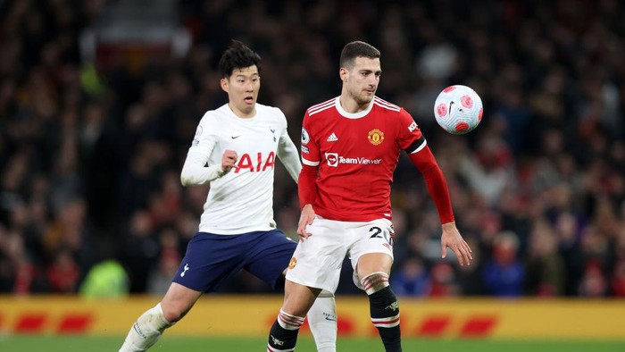MANCHESTER, ENGLAND - MARCH 12: Heung-Min Son of Tottenham Hotspur looks on as Diogo Dalot of Manchester United controls the ball during the Premier League match between Manchester United and Tottenham Hotspur at Old Trafford on March 12, 2022 in Manchester, England. (Photo by Naomi Baker/Getty Images)
