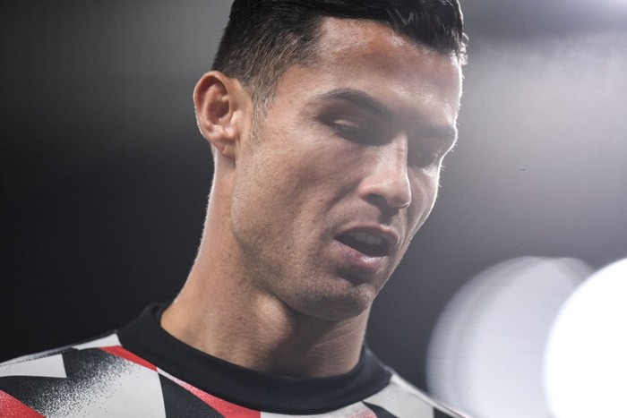 Manchester Uniteds Portuguese striker Cristiano Ronaldo reacts during the warm up prior to the English Premier League football match between Manchester United and Tottenham Hotspur at Old Trafford in Manchester, north west England, on October 19, 2022. - RESTRICTED TO EDITORIAL USE. No use with unauthorized audio, video, data, fixture lists, club/league logos or live services. Online in-match use limited to 120 images. An additional 40 images may be used in extra time. No video emulation. Social media in-match use limited to 120 images. An additional 40 images may be used in extra time. No use in betting publications, games or single club/league/player publications. (Photo by Oli SCARFF / AFP) / RESTRICTED TO EDITORIAL USE. No use with unauthorized audio, video, data, fixture lists, club/league logos or live services. Online in-match use limited to 120 images. An additional 40 images may be used in extra time. No video emulation. Social media in-match use limited to 120 images. An additional 40 images may be used in extra time. No use in betting publications, games or single club/league/player publications. / RESTRICTED TO EDITORIAL USE. No use with unauthorized audio, video, data, fixture lists, club/league logos or live services. Online in-match use limited to 120 images. An additional 40 images may be used in extra time. No video emulation. Social media in-match use limited to 120 images. An additional 40 images may be used in extra time. No use in betting publications, games or single club/league/player publications. (Photo by OLI SCARFF/AFP via Getty Images)