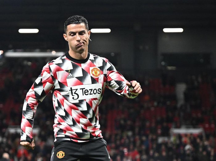 Manchester United's Portuguese striker Cristiano Ronaldo reacts during the warm up prior to the English Premier League football match between Manchester United and Tottenham Hotspur at Old Trafford in Manchester, north west England, on October 19, 2022. - RESTRICTED TO EDITORIAL USE. No use with unauthorized audio, video, data, fixture lists, club/league logos or 'live' services. Online in-match use limited to 120 images. An additional 40 images may be used in extra time. No video emulation. Social media in-match use limited to 120 images. An additional 40 images may be used in extra time. No use in betting publications, games or single club/league/player publications. (Photo by Oli SCARFF / AFP) / RESTRICTED TO EDITORIAL USE. No use with unauthorized audio, video, data, fixture lists, club/league logos or 'live' services. Online in-match use limited to 120 images. An additional 40 images may be used in extra time. No video emulation. Social media in-match use limited to 120 images. An additional 40 images may be used in extra time. No use in betting publications, games or single club/league/player publications. / RESTRICTED TO EDITORIAL USE. No use with unauthorized audio, video, data, fixture lists, club/league logos or 'live' services. Online in-match use limited to 120 images. An additional 40 images may be used in extra time. No video emulation. Social media in-match use limited to 120 images. An additional 40 images may be used in extra time. No use in betting publications, games or single club/league/player publications. (Photo by OLI SCARFF/AFP via Getty Images)