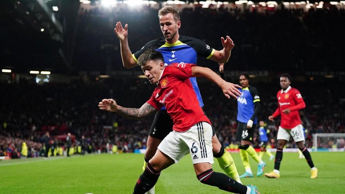 Tottenham Hotspur's Harry Kane and Manchester United's Lisandro Martinez (right) battle for the ball during the Premier League match at Old Trafford, Manchester. Picture date: Wednesday October 19, 2022. (Photo by Nick Potts/PA Images via Getty Images)