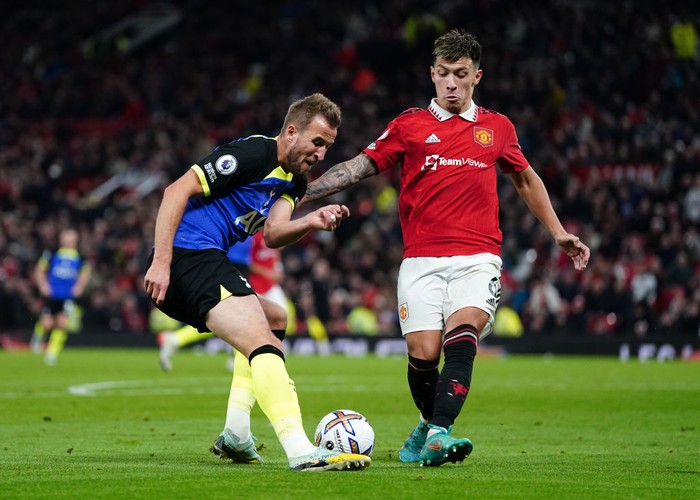 Tottenham Hotspur's Harry Kane and Manchester United's Lisandro Martinez (right) battle for the ball during the Premier League match at Old Trafford, Manchester. Picture date: Wednesday October 19, 2022. (Photo by Nick Potts/PA Images via Getty Images)