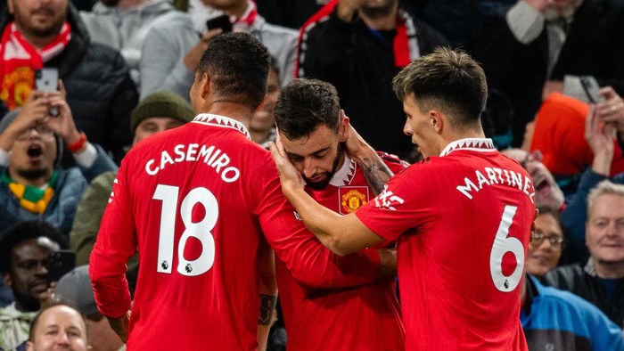 MANCHESTER, ENGLAND - OCTOBER 19:   Bruno Fernandes of Manchester United celebrates with Casemiro  and Lisandro Martinez of Manchester United during the Premier League match between Manchester United and Tottenham Hotspur at Old Trafford on October 19, 2022 in Manchester, United Kingdom. (Photo by Ash Donelon/Manchester United via Getty Images)