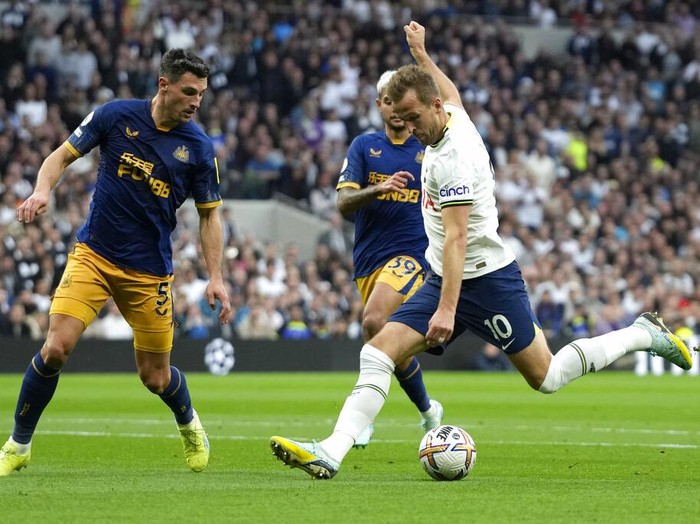 Newcastle's goalkeeper Nick Pope, left, punches the ball away under pressure from Tottenham's Davinson Sanchez, right, during the English Premier League soccer match between Tottenham Hotspur and Newcastle United at the Tottenham Hotspur Stadium in London, England, Sunday, Oct. 23, 2022. (AP Photo/Frank Augstein)