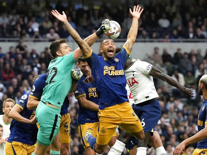 Newcastle's goalkeeper Nick Pope, left, punches the ball away under pressure from Tottenham's Davinson Sanchez, right, during the English Premier League soccer match between Tottenham Hotspur and Newcastle United at the Tottenham Hotspur Stadium in London, England, Sunday, Oct. 23, 2022. (AP Photo/Frank Augstein)