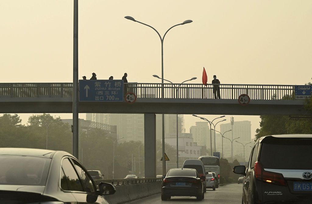 A security guard is seen at an overpass near the Sitong Bridge in Beijing on October 14, 2022, where protest banners with slogans criticising the Communist Party's policies were hanged the day before, ahead of China's 20th Communist Party Congress. - China's internet censors removed on Friday virtually all references to reports of a rare protest in Beijing that involved banners denouncing President Xi Jinping and the country's Covid policies. (Photo by Noel Celis / AFP) (Photo by NOEL CELIS/AFP via Getty Images)