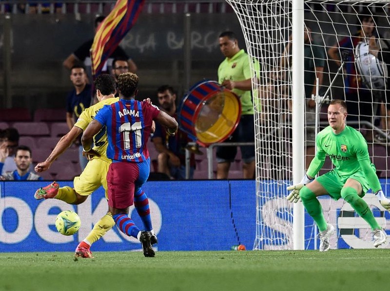 Villarreal's Spanish defender Alfonso Pedraza (L) shoots and scores a goal past Barcelona's German goalkeeper Marc-Andre ter Stegen (R) during the Spanish League football match between FC Barcelona and Villarreal CF at the Camp Nou stadium in Barcelona on May 22, 2022. (Photo by Josep LAGO / AFP) (Photo by JOSEP LAGO/AFP via Getty Images)