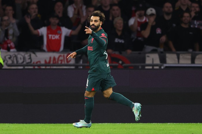AMSTERDAM, NETHERLANDS - OCTOBER 26: Mohamed Salah of Liverpool celebrates after scoring a goal to make it 0-1 during the UEFA Champions League group A match between AFC Ajax and Liverpool FC at Johan Cruyff Arena on October 26, 2022 in Amsterdam, Netherlands. (Photo by Matthew Ashton - AMA/Getty Images)