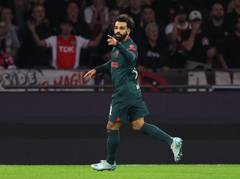 AMSTERDAM, NETHERLANDS - OCTOBER 26: Mohamed Salah of Liverpool celebrates after scoring a goal to make it 0-1 during the UEFA Champions League group A match between AFC Ajax and Liverpool FC at Johan Cruyff Arena on October 26, 2022 in Amsterdam, Netherlands. (Photo by Matthew Ashton - AMA/Getty Images)