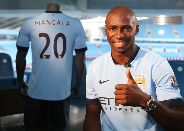 Eliaquim Mangala Barclays Premier League, Manchester City, Eliaquim Mangala signing, Etihad Stadium, Eliaquim Mangala holding up his shirt in the dressing room (Photo by Victoria Haydn/Manchester City FC via Getty Images)