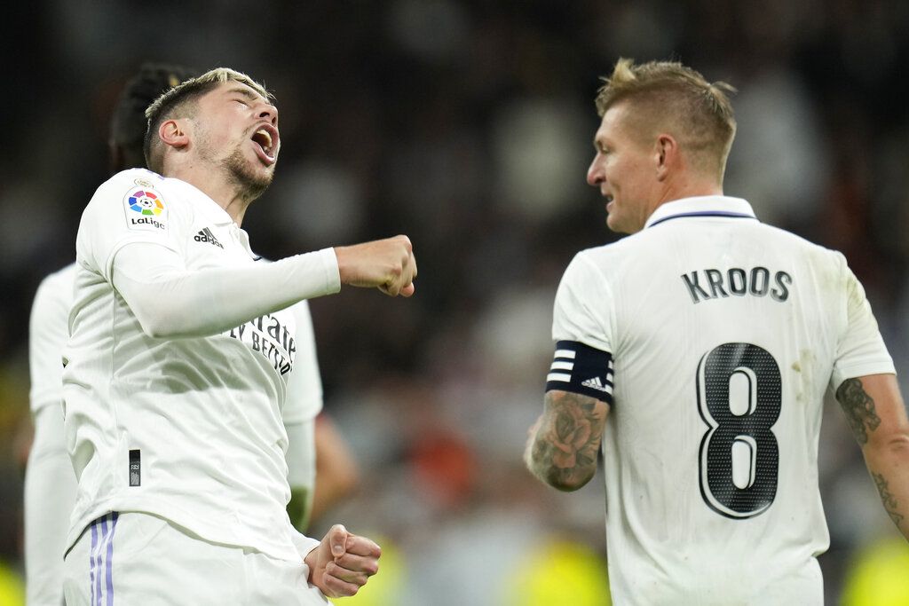 Real Madrid's Federico Valverde, left, celebrates with Toni Kroos after scoring his side's third goal during the Spanish La Liga soccer match between Real Madrid and Sevilla at the Santiago Bernabeu stadium in Madrid, Saturday, Oct. 22, 2022. (AP Photo/Manu Fernandez)