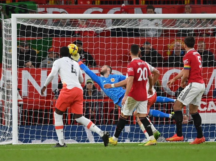 MANCHESTER, ENGLAND - OCTOBER 30: David De Gea of Manchester United makes a save from Kurt Zouma of West Ham United during the Premier League match between Manchester United and West Ham United at Old Trafford on October 30, 2022 in Manchester, England. (Photo by Michael Regan/Getty Images)