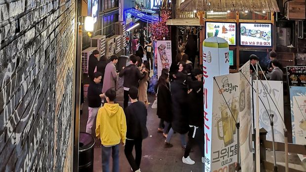 Crowd of people at night in Itaewon, a popular area in Seoul known as 