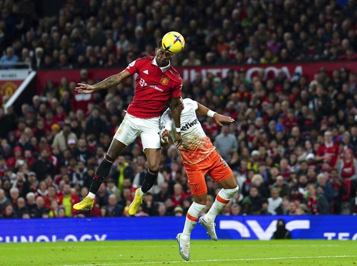 Manchester United's Marcus Rashford, top left, scores his side's opening goal during the English Premier League soccer match between Manchester United and West Ham United at Old Trafford stadium in Manchester, England, Sunday, Oct. 30, 2022. (David Davies/PA via AP)