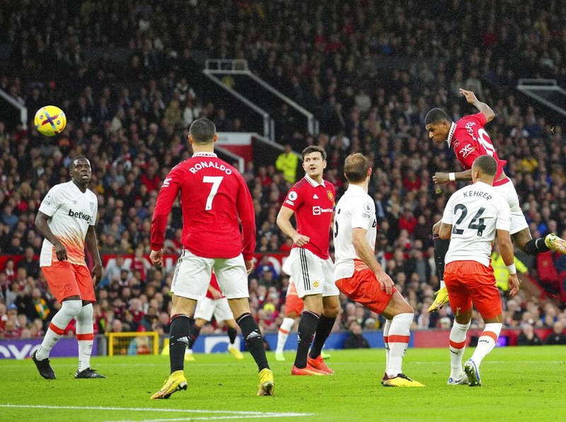 Manchester United's Marcus Rashford, right, attempts a head at goal during the English Premier League soccer match between Manchester United and West Ham United at Old Trafford stadium in Manchester, England, Sunday, Oct. 30, 2022. (AP Photo/Jon Super)