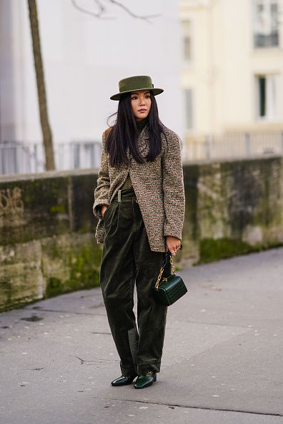 PARIS, FRANCE - FEBRUARY 29: Yoyo Cao wears a green khaki hat from Ruslan Baginskiy, a Chanel tweed jacket, a green rigid case bag with crocodile pattern, green/khaki pants, pointy leather shoes, outside Elie Saab, during Paris Fashion Week - Womenswear Fall/Winter 2020/2021, on February 29, 2020 in Paris, France. (Photo by Edward Berthelot/Getty Images)