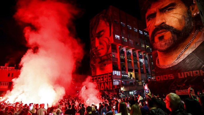 Fans mark Diego Maradona's birthday in the San Giovanni district under a mural of the soccer legend on Sunday, Oct., 30, 2022, in Napoli, Italy. (Alessandro Garofalo/LaPresse via AP)