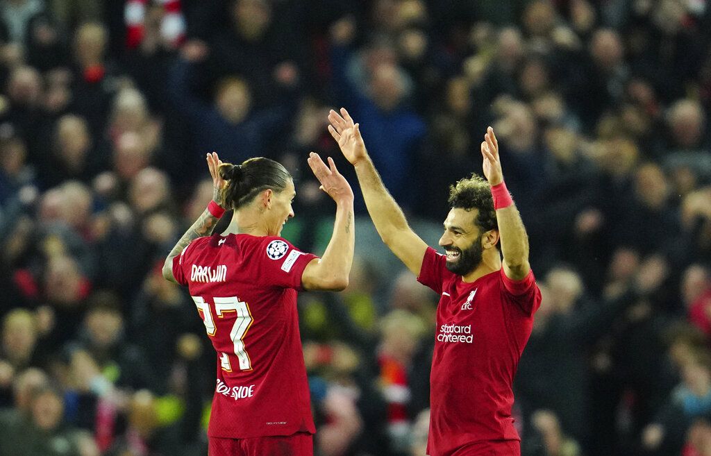 Liverpool's Darwin Nunez, left, and Liverpool's Mohamed Salah celebrate at the end of the Champions League Group A soccer match between Liverpool and Napoli, at Anfield stadium in Liverpool, England, Tuesday, Nov. 1, 2022. (AP Photo/Jon Super)
