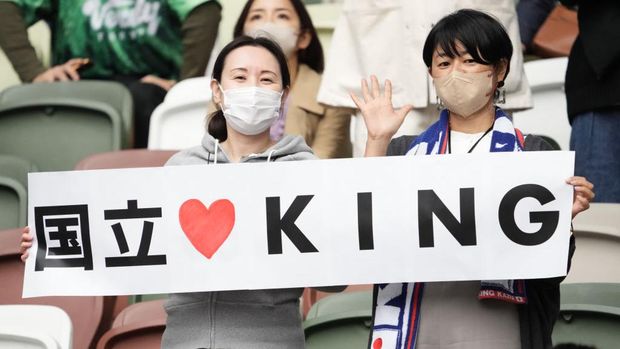 TOKYO, JAPAN - OCTOBER 09: Fans of Kazuyoshi Miura cheer after the JFL match between Criacao Shinjuku and Suzuka Point Getters at the National Stadium on October 09, 2022 in Tokyo, Japan. (Photo by Hiroki Watanabe/Getty Images)