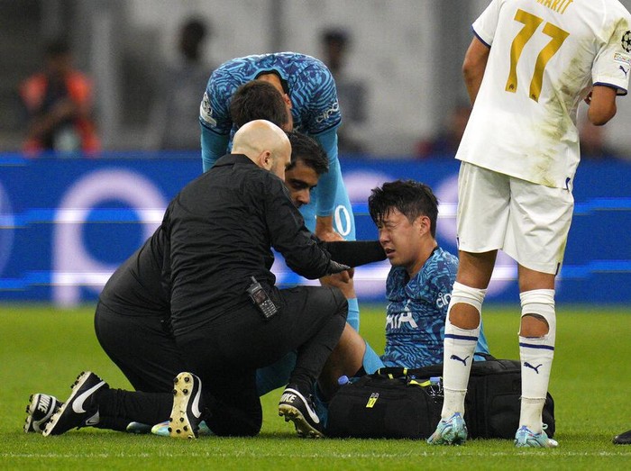 Tottenham's Son Heung-min receives treatment after taking a knock during the Champions League Group D soccer match between Marseille and Tottenham Hotspur at the Stade Velodrome in Marseille, France, Tuesday, Nov. 1, 2022. (AP Photo/Daniel Cole)
