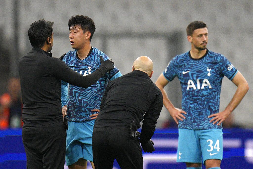 Tottenham's Son Heung-min receives treatment after taking a knock during the Champions League Group D soccer match between Marseille and Tottenham Hotspur at the Stade Velodrome in Marseille, France, Tuesday, Nov. 1, 2022. (AP Photo/Daniel Cole)