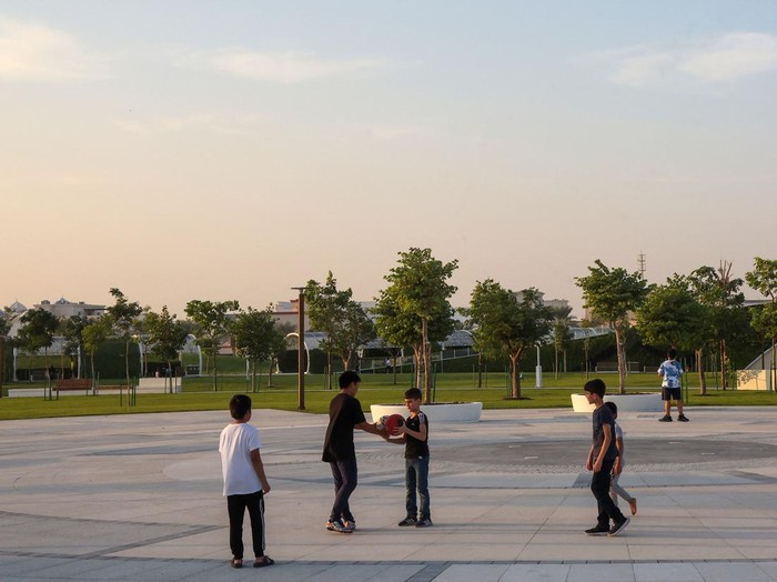 Children play football at the Umm Al Seneem Park, which has the world's longest air-conditioned outdoor path, in Doha on November 2, 2022. (Photo by KARIM JAAFAR / AFP) (Photo by KARIM JAAFAR/AFP via Getty Images)
