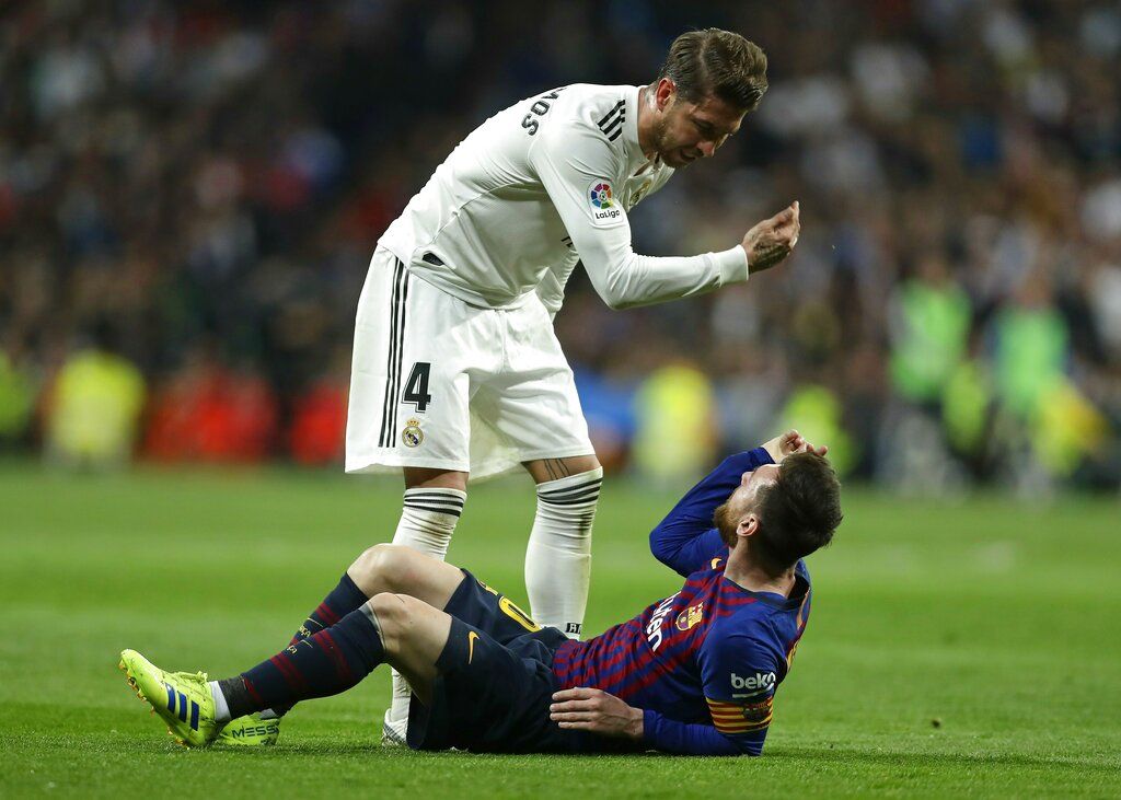FILE - In this March 2, 2019 file photo, Barcelona forward Lionel Messi, left, goes head to head with Real defender Sergio Ramos as they argue during the Spanish La Liga soccer match between Real Madrid and FC Barcelona at the Bernabeu stadium in Madrid. The Spanish football league on Wednesday Oct. 16. 2019, has asked the Spanish football federation to change the location of the match between Barcelona and Real Madrid to avoid it coinciding with plans for a separatist rally. The league wants the federation to shift the match to Madrid. (AP Photo/Manu Fernandez, File)