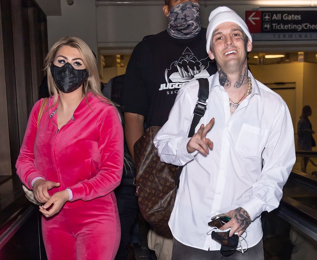 1311590311 PHILADELPHIA, PENNSYLVANIA - APRIL 08: Aaron Carter (R) and his fiancée Melanie Martin are seen arriving to Philadelphia International Airport for his upcoming Celebrity Boxing Face Off between Lamar Odom & Aaron Carter on April 08, 2021 in Philadelphia, Pennsylvania. (Photo by Gilbert Carrasquillo/GC Images)