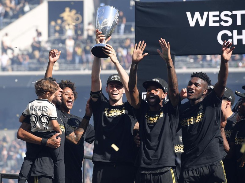 LOS ANGELES, CA - OCTOBER 30: Gareth Bale #11 of Los Angeles FC holds the championship trophy as he celebrates with teammates after defeating Austin FC, 3-0, during the Western Conference Finals of the 2022 MLS Cup Playoffs at Banc of California Stadium on October 30, 2022 in Los Angeles, California. (Photo by Kevork Djansezian/Getty Images)