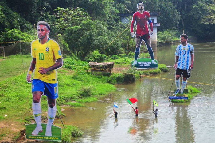 Neymar, Ronaldo, Messi Fans wave flags next to the giant cutouts of players from Brazil's Neymar (L), Portuguese Cristiano Ronaldo (C) and Argentine Lionel Messi, erected by football fans in river Cherupuzha at Kozhikode in India's Kerala state on November 7, 2022, ahead of the Qatar 2022 FIFA World Cup football tournament. (Photo by AFP) (Photo by -/AFP via Getty Images)