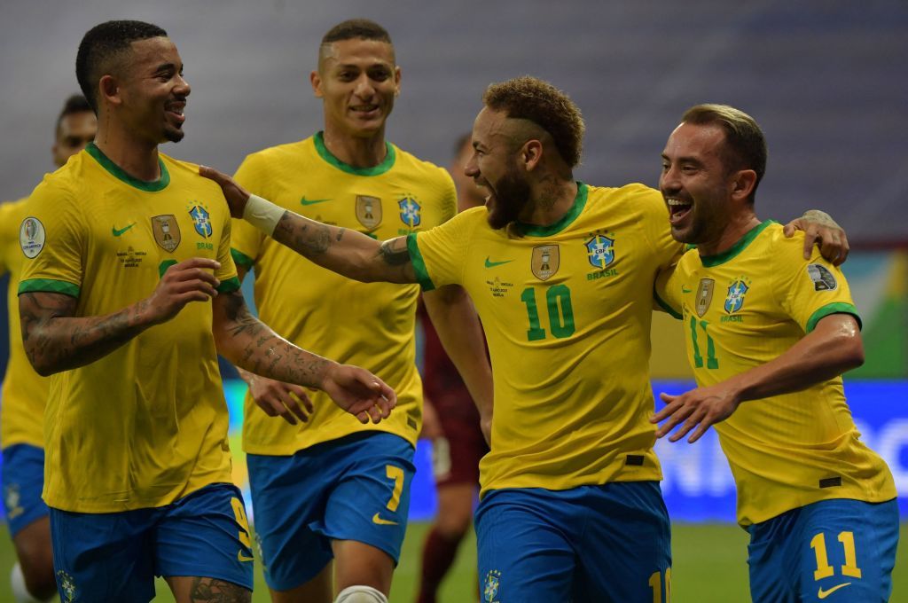 Brazil's Neymar (2nd R) celebrates with teammates (L to R) Gabriel Jesus, Richarlison and Everton Ribeiro after scoring against Venezuela during the Conmebol Copa America 2021 football tournament group phase match at the Mane Garrincha Stadium in Brasilia on June 13, 2021. (Photo by NELSON ALMEIDA / AFP) (Photo by NELSON ALMEIDA/AFP via Getty Images)