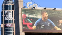 Sebuah papan reklame dengan gambar striker Prancis Kylian Mbappe ditampilkan di depan potret Emir Qatar Sheikh Tamim bin Hamad al-Thani di Doha.