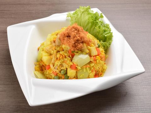 Thai golden pineapple wok fried rice with chicken floss on wood table asian halal menu