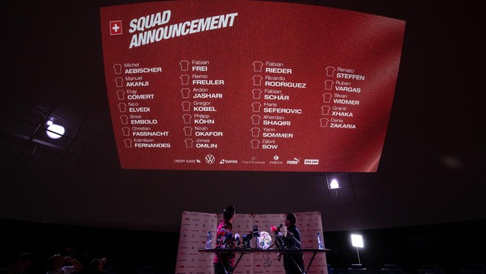 Switzerlands coach Murat Yakin (L) and Swiss FA head of communication Adrian Arnold looks at a giant screen during a press conference to announce the list of players of the Swiss squad for the upcoming Qatar 2022 World Cup football tournament in Lucerne, on November 9, 2022. (Photo by Fabrice COFFRINI / AFP) (Photo by FABRICE COFFRINI/AFP via Getty Images)