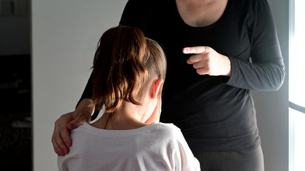 Mother telling off and discipline naughty daughter (age 10).