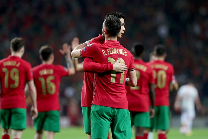 Portugals midfielder Bruno Fernandes (R ) celebrates with Cristiano Ronaldo after scoring a goal during the 2022 FIFA World Cup Qualifier football match between Portugal and North Macedonia at the Dragao stadium in Porto, Portugal, on March 29, 2022. (Photo by Pedro Fiúza/NurPhoto via Getty Images)