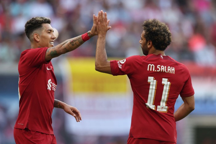 LEIPZIG, GERMANY - JULY 21: Mohamed Salah celebrates with Roberto Firmino of Liverpool after scoring their teams first goal during the pre-season friendly match between RB Leipzig and Liverpool FC at Red Bull Arena on July 21, 2022 in Leipzig, Germany. (Photo by Alexander Hassenstein/Getty Images)