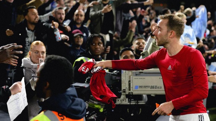 LONDON, ENGLAND - NOVEMBER 13: Christian Eriksen of Manchester United gives his shirt to a fan after the Premier League match between Fulham FC and Manchester United at Craven Cottage on November 13, 2022 in London, England. (Photo by Jared Martinez/Manchester United via Getty Images)