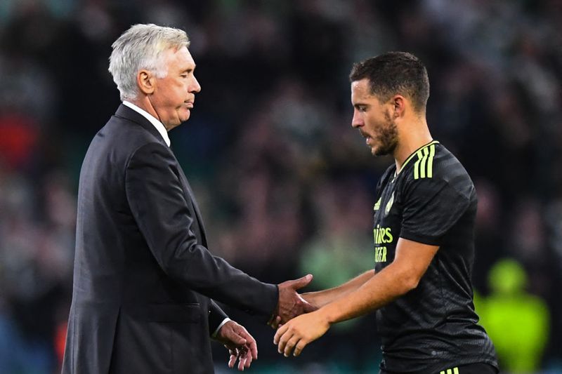 Real Madrid's Italian coach Carlo Ancelotti (L) congratulates Real Madrid's Belgian forward Eden Hazard at the end the UEFA Champions League Group F football match between Celtic and Real Madrid, at the Celtic Park stadium, in Glasgow, on September 6, 2022. - Real Madrid won 3 - 0 against Celtic. (Photo by ANDY BUCHANAN / AFP) (Photo by ANDY BUCHANAN/AFP via Getty Images)