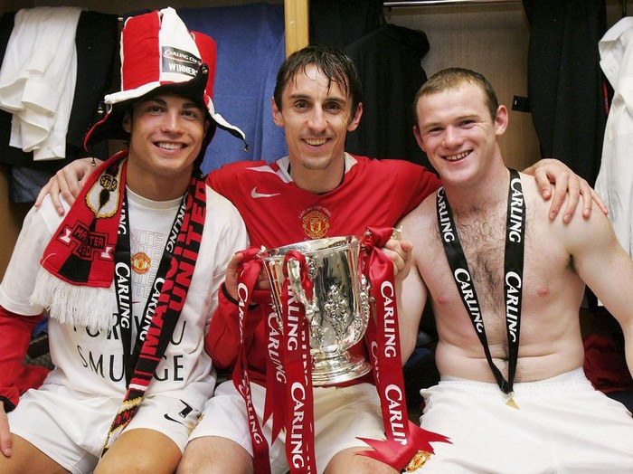 CARDIFF, WALES - FEBRUARY 26: Cristiano Ronaldo, Gary Neville and Wayne Rooney of Manchester United pose with the Carling Cup trophy in the dressing room after the Carling Cup Final match between Manchester United and Wigan Athletic at The Millennium Stadium on February 26 2006 in Cardiff, Wales. (Photo by John Peters/Manchester United via Getty Images)