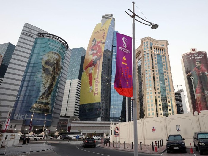 DOHA, QATAR - NOVEMBER 14: Images of Gareth Bale of Wales, Hassan Al-Haydos of Qatar and the FIFA World Cup trophy are seen on sky scrapers in the West Bay area ahead of the FIFA World Cup Qatar 2022 on November 14, 2022 in Doha, Qatar. (Photo by Catherine Ivill/Getty Images)
