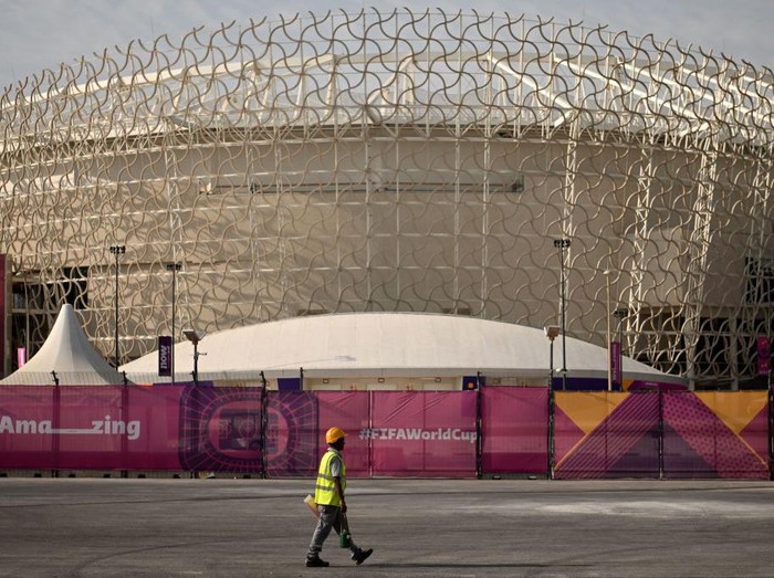 A man walks past the Ahmed bin Ali Stadium in Al-Rayyan on November 12, 2022, ahead of the Qatar 2022 FIFA World Cup football tournament. (Photo by Kirill KUDRYAVTSEV / AFP) (Photo by KIRILL KUDRYAVTSEV/AFP via Getty Images)