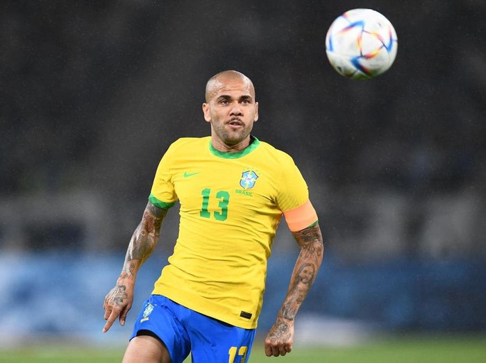 Brazil's Dani Alves runs with the ball during the friendly football match between Japan and Brazil at the National Stadium in Tokyo on June 6, 2022. (Photo by Charly TRIBALLEAU / AFP) (Photo by CHARLY TRIBALLEAU/AFP via Getty Images)