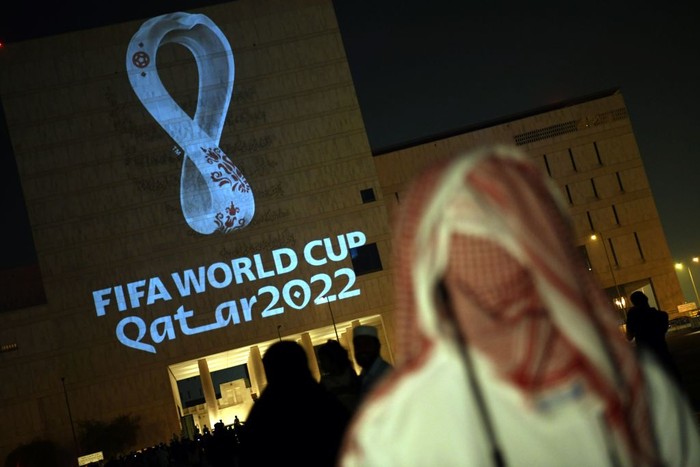 People gather at the capital Dohas traditional Souq Waqif market while the official logo of the FIFA World Cup Qatar 2022 is projected on the front of a building on September 3, 2019. (Photo by - / AFP)        (Photo credit should read -/AFP via Getty Images)