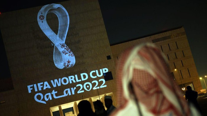 People gather at the capital Dohas traditional Souq Waqif market while the official logo of the FIFA World Cup Qatar 2022 is projected on the front of a building on September 3, 2019. (Photo by - / AFP)        (Photo credit should read -/AFP via Getty Images)