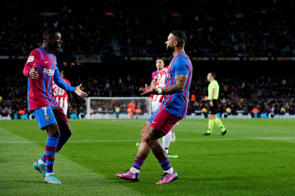 Barcelona's Dutch forward Memphis Depay (L) celebrates with Barcelona's French forward Ousmane Dembele after scoring a goal during the Spanish league football match between FC Barcelona and Athletic Club Bilbao at the Camp Nou stadium in Barcelona on February 27, 2022. (Photo by Pau BARRENA / AFP) (Photo by PAU BARRENA/AFP via Getty Images)